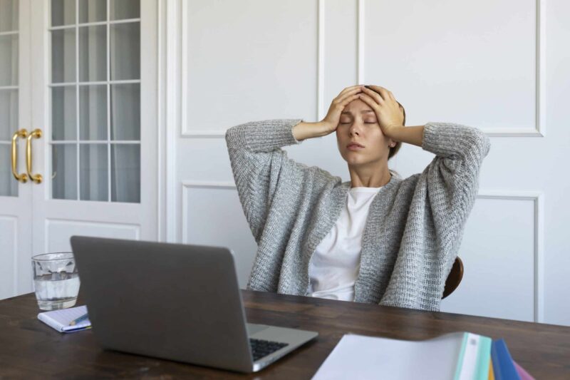 medium shot worried woman desk scaled e1749371759893